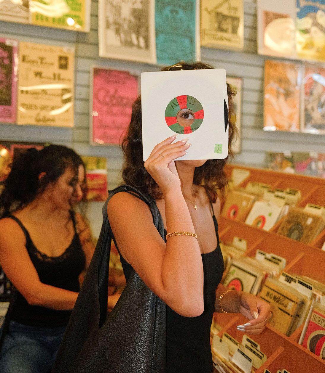 a woman holding an album cover