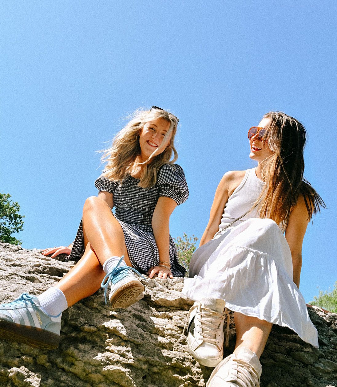 two girls sitting and smiling